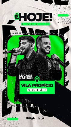 two men singing into microphones in front of a green and black poster with words above them