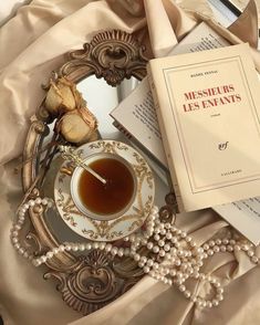 a cup of tea and some books on a table