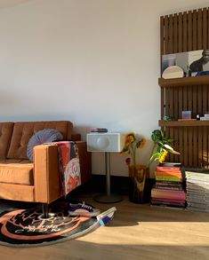 a living room filled with furniture and bookshelves next to a wall mounted book shelf