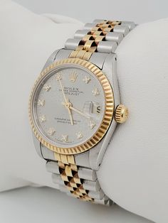 Women's Rolex DateJust 31mm Two Tone 18K Yellow Gold / Stainless Steel Watch with Silver Diamond Dial and Fluted Bezel. Pre-Owned SN# L20**** Brand: Rolex. Dial: Diamond. Gender: Ladies. Model: DateJust. Case Back: Solid. Dial Color: Silver. Crystal: Sapphire. Case Dimensions: 31mm. Bezel Color: 18K Yellow Gold. Movement: Mechanical (Automatic). Metal Type: 18K Gold / Stainless Steel. Bracelet / Strap: 18K Yellow Gold / Stainless Steel. Box / Certificate: Rolex Box / In-House Certificate. Warran Rolex Datejust 31 Women, Lirika Matoshi, Zenith Watches, Rolex Watches Women, Chanel Watch, Rolex Women, Wrist Jewelry, White Gold Sapphire, Dream Watches