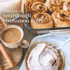 the famous sourdough cinnamon rolls are served on a plate next to a cup of coffee