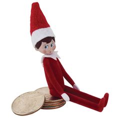 the elf is sitting on top of some coins