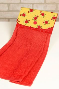 a pair of red socks sitting on top of a white counter next to a brick wall