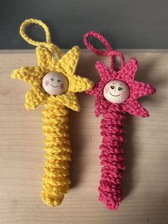 two crocheted toys with faces on them