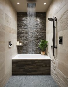 a bath room with a tub and a shower head mounted to the side of it