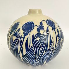 a blue and white vase with flowers on it