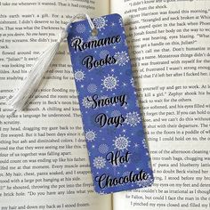 a bookmark with the words romance books snowy days hot chocolate on it and snowflakes