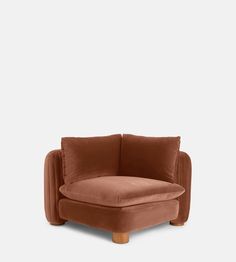 the corner chair in brown velvet with wooden legs