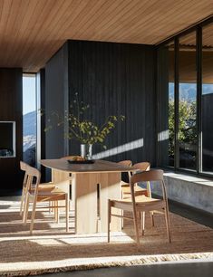 a table with chairs and a vase on it