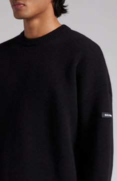 Stretch-hinted wool softens and refines this oversized crewneck sweater branded with a logo-embossed rubber tag on the left sleeve. 29 1/2" length (size Medium) Crewneck Long sleeves Dropped shoulders Ribbed cuffs and hem 97% wool, 2% polyamide, 1% elastane Dry clean Made in Italy Designer Clothing Luxury Crew Neck Sweatshirt For Winter, Luxury Crew Neck Winter Sweatshirt, Wool Crew Neck Sweater For Streetwear, Luxury Crew Neck Sweater For Fall, Luxury Crew Neck Fall Sweater, Oversized Merino Wool Crew Neck Top, Luxury Fall Sweatshirt, Oversized Wool Crew Neck Top, Oversized Wool Top With Crew Neck