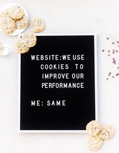 cookies on a table with a sign that says website - use cookies to improve our performance me same