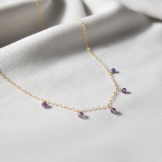 "This hand made necklace features a stunning selection of Amethyst dewdrops, perfectly arranged on a dainty but durable chain in your preferred finish. This necklace makes a wonderful gift for an Aquarius/Pisces or an Amethyst-lover in your family or friend circle. Chain Options: * Sterling Silver * Gold Filled * Rose Gold Filled Necklace Length Guide: * 14\"-15\" lays closely around neck * 16\" fits loosely around neck * 18\" lays on collarbone * 20\" lays just below collarbone * 22\" lays just Teardrop Stones For Jewelry Making Necklaces, Purple Drop Necklace For Gift, Dainty Gemstone Drop Necklace, Dainty Birthstone Dangle Necklaces, Dainty Crystal Necklaces With Gemstone Dangle, Dainty Teardrop Pendant Necklace With Natural Stones, Dainty Dangle Birthstone Necklaces, Handmade Dainty Drop Necklaces, Drop Necklace With Stones As Gift