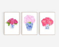 three pink flowers in blue and white vases