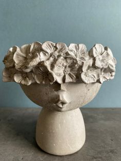 a white vase filled with flowers on top of a table