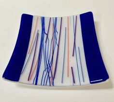 a blue and white plate with lines painted on it