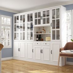 a room with blue walls and white cabinets