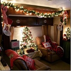 a living room filled with furniture and christmas decorations