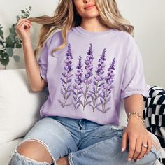 Embrace the serene beauty of nature with our 'Lavender' comfort colors t-shirt. Adorned with a graceful lavender design, this tee captures the essence of endless lavender fields under the summer sky. Crafted from lightweight, breathable fabric, it's the perfect blend of comfort and style for any casual occasion. Ideal for those who find solace in the soothing scent and sight of lavender, this shirt brings a piece of the tranquil outdoors to your everyday wardrobe. Whether you're strolling throug Summer Lavender Tops With Graphic Print, Lavender Graphic Print Tops For Summer, Lavender Tops With Graphic Print For Summer, Lavender Cotton Summer Shirt, Lavender Short Sleeve T-shirt For Summer, Lavender Cotton Shirt For Summer, Casual Lavender Cotton Top, Lavender Relaxed Fit T-shirt For Spring, Lavender Floral Print Cotton Top