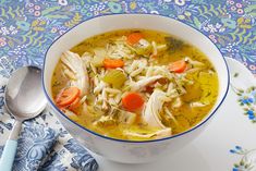 a bowl of chicken noodle soup with carrots and celery