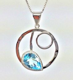 "Hi everyone, just wanted to let you know we are open and shipping daily. Real Blue Topaz Silver Pendant with CZ Accents // Rhodium Finished // 16\" Chain Included 16 inch box chain included." Sterling Silver Round Necklace With Gemstone Accents, Sterling Silver Necklace With Gemstone Accents, Silver Topaz Necklaces With Birthstone, Silver Topaz Birthstone Necklaces, Round Topaz Necklaces With Diamond Accents, Round Topaz Necklace With Diamond Accents, Blue Topaz Teardrop Pendant Jewelry For Anniversary, Blue Topaz Teardrop Pendant For Anniversary, Drop Topaz Jewelry For Anniversary