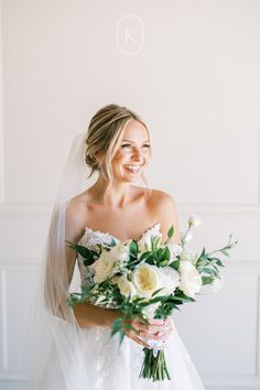 a woman in a wedding dress holding a bouquet