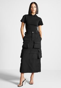 Cargo Black Skirt Outfit, Black Utility Skirt Outfit, Black Utility Cargo Skirt With Multiple Pockets, Chic Black Cargo Skirt With Side Pockets, Black Cargo Skirt Outfit, Black Cargo Skirt With Side Pockets, Black Cotton Cargo Skirt With Pockets, Midi Skirt And Boots, High-waisted Utility Cargo Skirt With Multiple Pockets