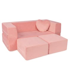 a pink couch and ottoman sitting on top of a white floor next to each other