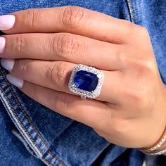 a woman's hand with a blue ring on it