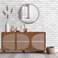 a white brick wall with a wooden cabinet and round mirror on it's sideboard