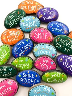 colorful painted rocks with words on them