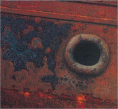 an old rusted metal object with a hole in the center