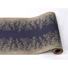 a roll of blue and white fabric with trees on it