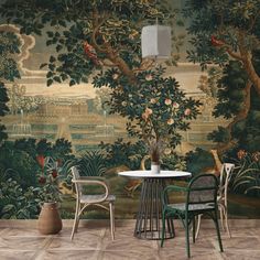 two chairs and a table in front of a wall mural