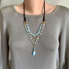 Add a touch of boho elegance to your everyday look with this wonderful Sundance Style gemstone layered necklace.   This captivating piece features a harmonious blend of aquamarine, rutilated quartz and a touch of apatite gemstones. The delicate layers of shimmering beads create a mesmerizing visual display.   The adjustable genuine leather cord ensures a comfortable and customizable fit, while the delicate gold-plated accents add a touch of luxurious sophistication. Let this magnificent necklace become your go to accessory or give it as a unique gift to someone special. It will arrive in a ribboned box and is carefully packaged in another box for shipping. Thank you for viewing and, if you have time, please browse through AERJewelryDesign. www.aerjewelrydesign.etsy.com Beads 4x 2mm, 6mm, 3 Pyrite Pendant, Sundance Style, Visual Display, Layered Jewelry, Multi Strand Necklace, Layered Necklace, Rutilated Quartz, Leather Jewelry, Leather Cord