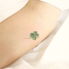 a small four leaf clover tattoo on the foot