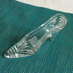 a glass object sitting on top of a green cloth