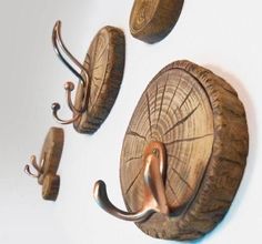 three metal hooks are attached to the side of a wooden wall mounted coat rack and hat hook