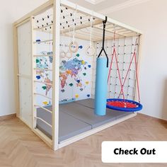 a child's play area with a blue ball and gym equipment