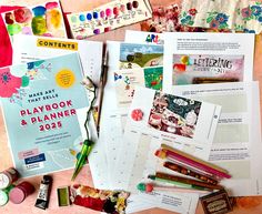 the contents of a play book and planner laid out on a table with crayons