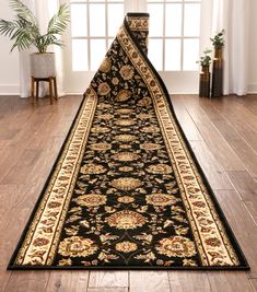 a black and gold runner rug in front of a window