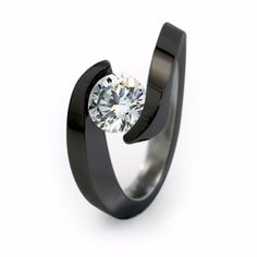 Low-profile solitaire stands out in this engagment ring stunning Black Titanium finish. Luxury Black Titanium Rings, Titanium Engagement Ring, Medieval Wedding Ring, Titanium Engagement Rings, Black Titanium Ring, Dark Rings, Jhumki Earrings, Titanium Ring, Titanium Jewelry