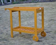 a small wooden cart sitting in the middle of a field