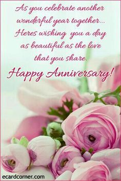 a bouquet of pink flowers sitting on top of a table next to a happy anniversary card