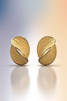 Gold stud earrings with leaf design. Flora collection. The earrings of the Flora collection have the shape of the ash leaf, a sacred tree in many cultures, a symbol of the sun and always used as a protection. The earrings feature wide and comfortable push back butterflies Ideal earrings for everyday elegance, a new talisman that will bring you luck and a good mood. The approximate weight is 3.5 grams per earring, for a total of about 7 grams. 14k or 18k gold 22 mm height 15 mm large designed and crafted in Italy ❥ Production time for custom design A new customized solid gold piece will take from 3 to 4 weeks to be designed and finished.  In case of a particular gemstone request, the time of production will result a little bit longer. If you have any special requests or questions, please do Ash Leaf, Sacred Tree, Oval Stud Earrings, Metal Clay Jewelry, 18k Gold Earrings, Everyday Elegance, Gold Leaves, Gold Stud Earrings, Oval Earring