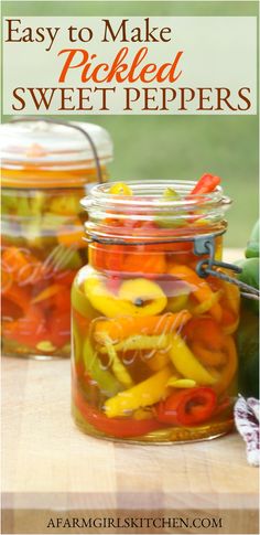 jars filled with pickled sweet peppers on top of a wooden table