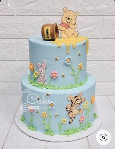 a winnie the pooh birthday cake with honey on top and fondant decorations for decoration