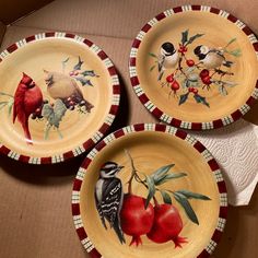 three plates with birds and berries painted on them