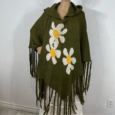 New With Tags. Rare & Discontinued Piece. Army Green Knit Hooded Poncho With Fringe, 3 60’s Style Daisies Knit Into The Poncho. Nonsmoking Home. Fabric & Care Tags Shown. Casual Hooded Spring Poncho, Casual Hooded Poncho For Spring, Vintage One-size Winter Poncho, Vintage Winter Poncho One Size, Hooded Outerwear For Spring, Hooded One Size Outerwear For Spring, One Size Vintage Poncho For Winter, Spring Bohemian Hooded Hoodie, Winter Green Hooded Poncho