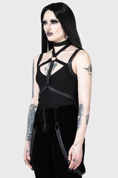 POWER SURGE.- Stretch fabric with PU straps.- Adjustable neck strap.- Back zip.- Fitted.- Model is wearing a plain black choker, there is no strap around the neck.With KIHILIST branding, Main body: 73% Viscose 23% Polyamide 4% Elastane, Straps: 60% Polyester 40% Polyurethane.Hand wash delicate (30°c) / Do not bleach / Do not tumble dry / Iron at a low temperature / Do not dry clean. Imported. Black Punk Harness For Festival, Black Punk Style Festival Harness, Black Punk Harness With Adjustable Straps, Edgy Black Harness For Festivals, Punk Black Harness With Adjustable Straps, Fitted Black Harness With Suspenders, Punk Style Black Harness With Adjustable Strap, Black Gothic Harness With Adjustable Straps, Gothic Fitted Harness With Adjustable Straps