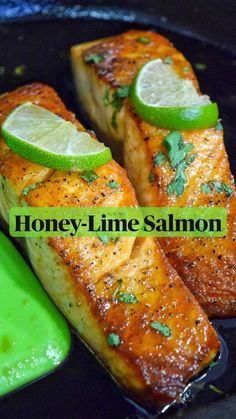 honey - lime salmon in a skillet with lemon wedges